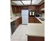 Clean and well-maintained kitchen featuring wood cabinetry and white appliances at 17404 N 99Th Ave # 136, Sun City, AZ 85373