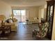 Comfortable living room with large windows and bright neutral decor at 17404 N 99Th Ave # 136, Sun City, AZ 85373