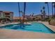 Community pool with lounge chairs and tropical landscaping at 17404 N 99Th Ave # 136, Sun City, AZ 85373