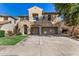 Charming two-story home featuring a three car garage and lush front yard at 18232 W Golden Ln, Waddell, AZ 85355