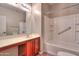 Bright bathroom featuring a shower and tub combination and cherry cabinets at 18474 N Celis St, Maricopa, AZ 85138