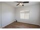Bedroom with ceiling fan, wood-look flooring, and a window at 18474 N Celis St, Maricopa, AZ 85138