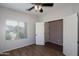 Well-lit bedroom showcasing a spacious closet and a bright window at 18474 N Celis St, Maricopa, AZ 85138