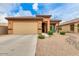 Charming single-story home with a well-maintained front yard and a two-car garage at 18474 N Celis St, Maricopa, AZ 85138