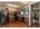 Bright kitchen featuring stainless steel appliances, wood cabinets, and hardwood floors at 18474 N Celis St, Maricopa, AZ 85138