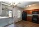 The kitchen features dark wood cabinets and a sliding glass door to the patio at 18474 N Celis St, Maricopa, AZ 85138