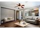 Bright living room with wood floors, contemporary furniture and ceiling fan at 18474 N Celis St, Maricopa, AZ 85138