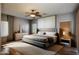 Serene bedroom with a ceiling fan, large windows and a well-placed nightstand at 18474 N Celis St, Maricopa, AZ 85138