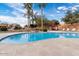 Resort-style swimming pool surrounded by lush landscaping, waterfalls, and comfortable lounge chairs at 2206 S Ellsworth Rd # 157B, Mesa, AZ 85209