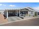 Single-story home with covered parking, a cozy front porch, and attractive two-tone color scheme at 2206 S Ellsworth Rd # 157B, Mesa, AZ 85209