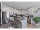 Open kitchen with stainless steel appliances and barstool seating at the center island at 2206 S Ellsworth Rd # 157B, Mesa, AZ 85209