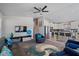 Open-concept living area with modern furnishings, including leather sofas and a ceiling fan at 2206 S Ellsworth Rd # 157B, Mesa, AZ 85209