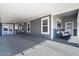 Relaxing covered patio with gray wood siding and rocking chairs at 2206 S Ellsworth Rd # 157B, Mesa, AZ 85209