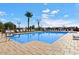 An expansive pool area with multiple lounge chairs, surrounded by palm trees at 2206 S Ellsworth Rd # 157B, Mesa, AZ 85209