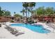 A serene pool area with a rock waterfall and lounge chairs, perfect for relaxation and recreation at 2206 S Ellsworth Rd # 157B, Mesa, AZ 85209