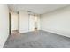 Spacious bedroom with carpet floors, white walls, and a barn door to the bathroom at 24953 S 190Th Dr, Buckeye, AZ 85326