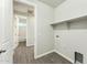 Neutral laundry room with a built-in shelf and washer/dryer hookups at 24953 S 190Th Dr, Buckeye, AZ 85326