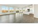 Spacious living area with ample windows and plank floors, flowing seamlessly into the modern kitchen at 24953 S 190Th Dr, Buckeye, AZ 85326