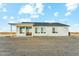 The rear of a single-story home with ample windows and a sliding glass door overlooking the backyard at 24953 S 190Th Dr, Buckeye, AZ 85326