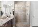 Bathroom featuring a tiled shower with glass door and a granite countertop at 26774 W Piute Ave, Buckeye, AZ 85396