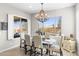 Bright dining room featuring a rustic chandelier and views of the backyard pool area at 26774 W Piute Ave, Buckeye, AZ 85396