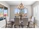 Bright dining room with a large window and an elegant chandelier at 26774 W Piute Ave, Buckeye, AZ 85396