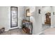 Inviting entryway features a decorative front door and stylish console table with decor at 26774 W Piute Ave, Buckeye, AZ 85396