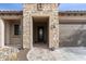 Inviting front entrance with stone details and a covered entryway at 26774 W Piute Ave, Buckeye, AZ 85396