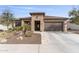 Charming front exterior with stone accents, desert landscaping, and a spacious driveway at 26774 W Piute Ave, Buckeye, AZ 85396