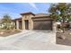 Well-maintained front exterior with desert landscaping and a two-car garage at 26774 W Piute Ave, Buckeye, AZ 85396