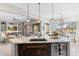 Open-concept kitchen with a center island, connecting to the living room and dining area at 26774 W Piute Ave, Buckeye, AZ 85396