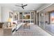 Comfortable living room featuring a decorative built-in shelving unit and a large sliding glass door at 26774 W Piute Ave, Buckeye, AZ 85396