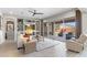 Bright living room with built-in shelves, large sliding glass doors, and neutral decor at 26774 W Piute Ave, Buckeye, AZ 85396