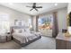 Serene main bedroom with a ceiling fan and large window overlooking the landscaped yard at 26774 W Piute Ave, Buckeye, AZ 85396