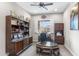 Office with dark wood furniture and window with plantation shutters at 26774 W Piute Ave, Buckeye, AZ 85396