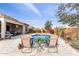 Relaxing backyard oasis with pool, outdoor kitchen, seating, and lush landscaping at 26774 W Piute Ave, Buckeye, AZ 85396