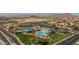 Aerial view of community pool, tennis courts, clubhouse, pond, and putting green at 32071 N Chestnut Trl, San Tan Valley, AZ 85143