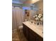 Well-lit bathroom featuring double sinks, a spacious vanity, and a shower-tub combination for added convenience at 32071 N Chestnut Trl, San Tan Valley, AZ 85143
