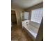 Bathroom featuring a bathtub with glass block window for natural light at 32071 N Chestnut Trl, San Tan Valley, AZ 85143