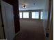 This is a large bedroom with big windows and neutral paint and carpet at 32071 N Chestnut Trl, San Tan Valley, AZ 85143