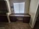 Desk area features granite countertop, dark cabinets, and a window view at 32071 N Chestnut Trl, San Tan Valley, AZ 85143