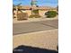 Single-story home with a two-car garage, desert landscaping and a paved street at 32071 N Chestnut Trl, San Tan Valley, AZ 85143