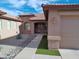 Welcoming front entrance with stone accents, a charming porch, and manicured artificial grass at 32071 N Chestnut Trl, San Tan Valley, AZ 85143