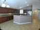 Bright, open kitchen with granite countertops, stylish cabinets, and a convenient center island at 32071 N Chestnut Trl, San Tan Valley, AZ 85143