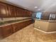 A spacious kitchen features granite countertops, stainless steel appliances, and ample dark wood cabinet space at 32071 N Chestnut Trl, San Tan Valley, AZ 85143