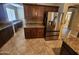 A kitchen is equipped with stainless steel refrigerator and appliances and granite countertops at 32071 N Chestnut Trl, San Tan Valley, AZ 85143
