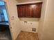 Functional laundry room features upper cabinets, providing storage solutions at 32071 N Chestnut Trl, San Tan Valley, AZ 85143