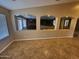 Open living room with tile flooring and kitchen views through arches at 32071 N Chestnut Trl, San Tan Valley, AZ 85143