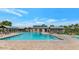 Large swimming pool surrounded by lounge chairs and shade structures on a sunny day at 32071 N Chestnut Trl, San Tan Valley, AZ 85143