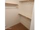 A walk-in closet with white walls, carpet, and wooden racks at 32071 N Chestnut Trl, San Tan Valley, AZ 85143